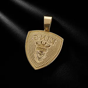 Detailed close-up of gold plated shield pendant featuring lion head with crown and KING logo
