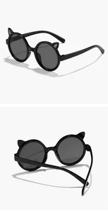 Detail view of cute black children's round sunglasses with decorative cat ears