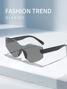 A detailed view of irregular rimless cat-eye sunglasses with grey lenses on a white base
