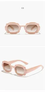 Detailed view of pink bubble frame children's rectangular sunglasses with brown lenses