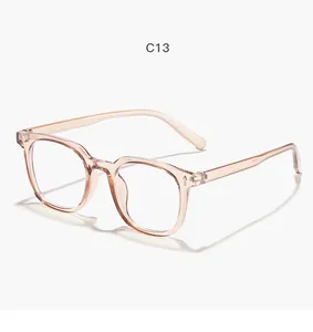 Lunettes carrées transparentes champagne avec rivets fléchés argentés