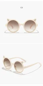 Cute cream cat-ear sunglasses for girls featuring gradient brown round lenses in detail