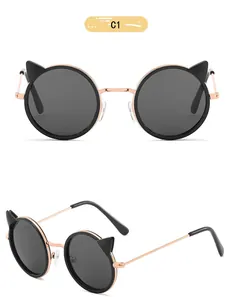 Detail view of children's round sunglasses with cute cat ear design and metal arms.