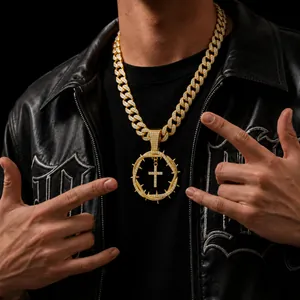 Detailed close-up of hip-hop gold plated iced-out thorn cross pendant with cuban chain