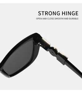 Close-up detail of the reinforced metal hinge on elegant black cat-eye sunglasses.