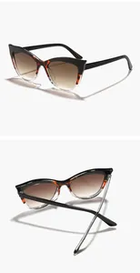 Detail of color-blocked cat-eye sunglasses with gradient brown lenses and UV400 protection
