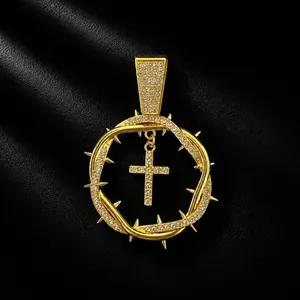 Detailed macro shot of iced out thorn circle pendant with a hanging cross in gold