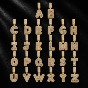 Macro view of iced out gold plated alphabet pendants A-Z with cubic zirconia stones