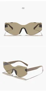 Detail of oversized irregular cat eye shield sunglasses with brown tinted lenses