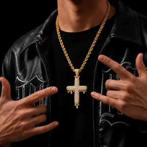 Close-up of hip-hop dripping cross pendant with cubic zirconia on gold rope chain