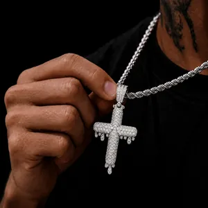 Detailed view of dripping cross pendant with sparkling zircon stones in hip hop style silver
