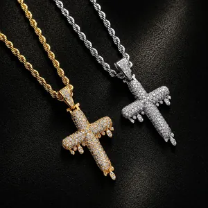 Close-up of hip hop dripping cross pendants featuring gold and silver plated cubic zirconia