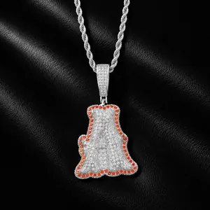 Macro detail of iced-out letter A pendant with white and orange zircon stones