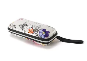 Detailed side view of a floral pattern hard shell glasses case with wrist strap