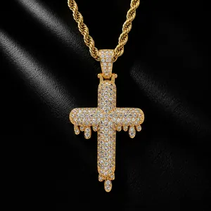 Detailed view of gold dripping cross pendant fully iced out with CZ stones on rope chain.