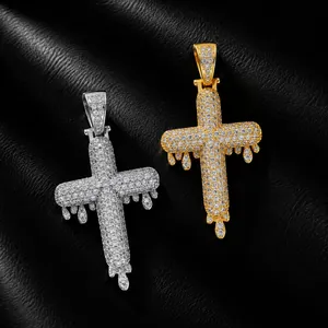 Detailed view of dripping cross pendants with full iced out cubic zirconia stones