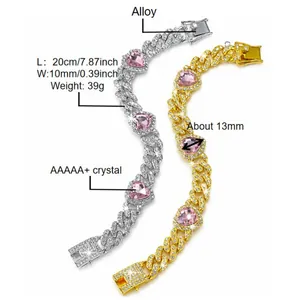 Detail view of iced out gold and silver Cuban link pet collars with pink heart crystals.