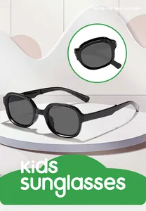 Detailed view of black foldable kids sunglasses on a white display stand