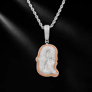Close-up view of a luxury iced out letter Q pendant with orange stones on silver rope chain