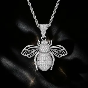 Exquisite macro detail of hip-hop bee pendant with iced-out stones and hollow wings