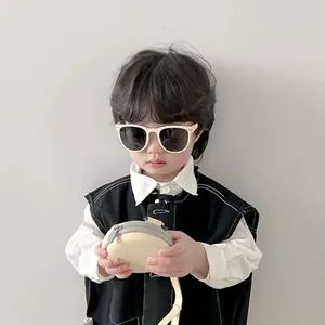 Stylish children's cream-colored square frame sunglasses worn by an Asian boy.