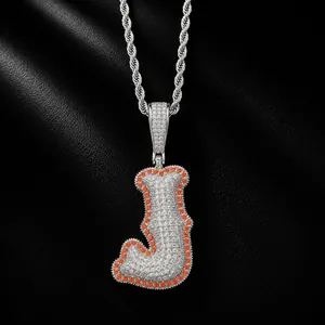 Close-up of hip-hop letter J pendant with brilliant white and orange pave zircon stones