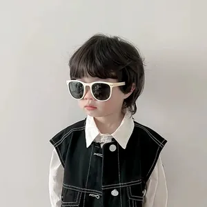 Close-up of a child wearing beige UV protection sunglasses, highlighting the frame design.