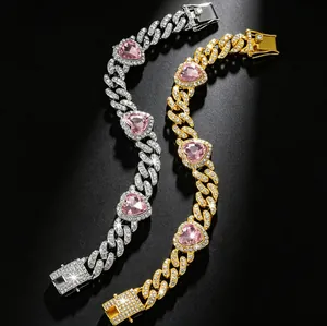 Close-up detail of iced-out Cuban link pet collars with pink heart-shaped stones