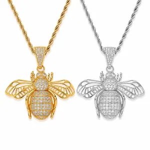 Detailed view of gold and silver iced out bee pendant necklaces with CZ micro pavé