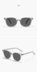 Detail view of classic square sunglasses with transparent grey frame and smoke lenses