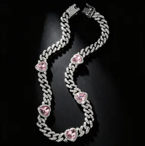 Detailed macro view of 10mm iced-out Cuban link pet collar with pink heart-shaped stones