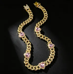 Detailed macro view of pink heart gemstones on iced out gold Cuban link pet collar
