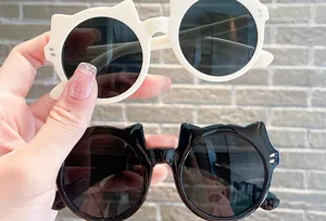 Close-up of cute cat-ear shaped children's sunglasses in stylish white and black colors