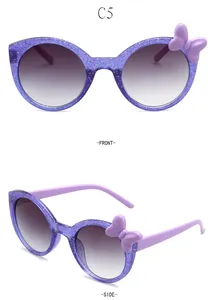Detail view of purple glitter children's round sunglasses with side bowtie decoration