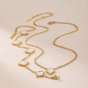 Detailed macro view of square mother-of-pearl pendants on a gold titanium steel chain.