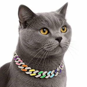 Close-up detail of a colorful rhinestone enamel Cuban link pet necklace on a gray cat