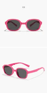 Detailed view of pink foldable square frame children's sunglasses with dark square lenses