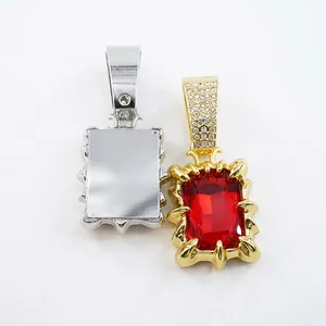Macro detail view of hip hop style pendant showing red gemstone and silver metal back plate