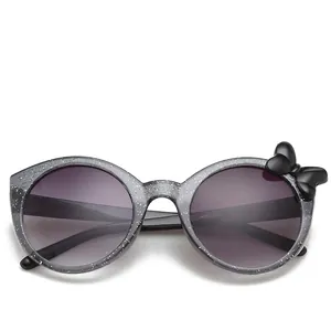 Stylish grey glitter round kids sunglasses with a black bow and dark gradient lenses