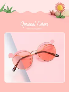 Close-up detail of children's pink sunglasses with metal bear ear frames and tinted lenses