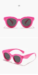 Detailed view of pink bubble round frame children's sunglasses with dark lenses