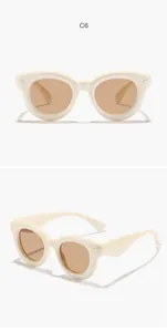 Detailed view of cream bubble round frame children's sunglasses with tinted lenses