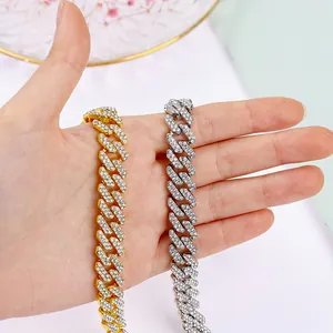 Detailed macro view of gold and silver iced out Cuban link chains for pets and fashion.