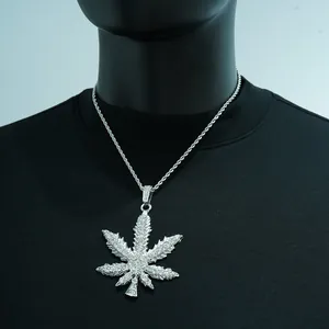 Detailed view of hip-hop iced-out maple leaf pendant necklace with glistening rhinestones