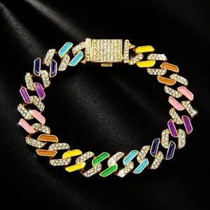 Macro detail of iced out Cuban link pet collar with colorful enamel and sparkling crystals
