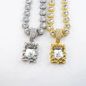 Close-up of gold and silver iced-out necklaces with large rectangular crystals