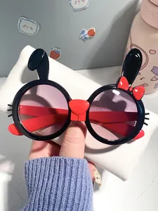 Close-up of cute rabbit-shaped children's sunglasses with bow and gradient lenses.