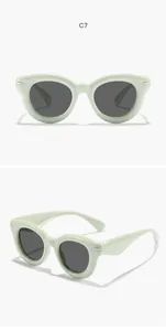 Detail view of mint green bubble round frame children's sunglasses with dark lenses