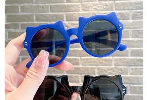 Close-up of adorable cat-ear children's sunglasses in vibrant blue and classic black