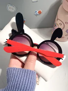 Close-up of cute rabbit-shaped children's sunglasses with purple gradient lenses.